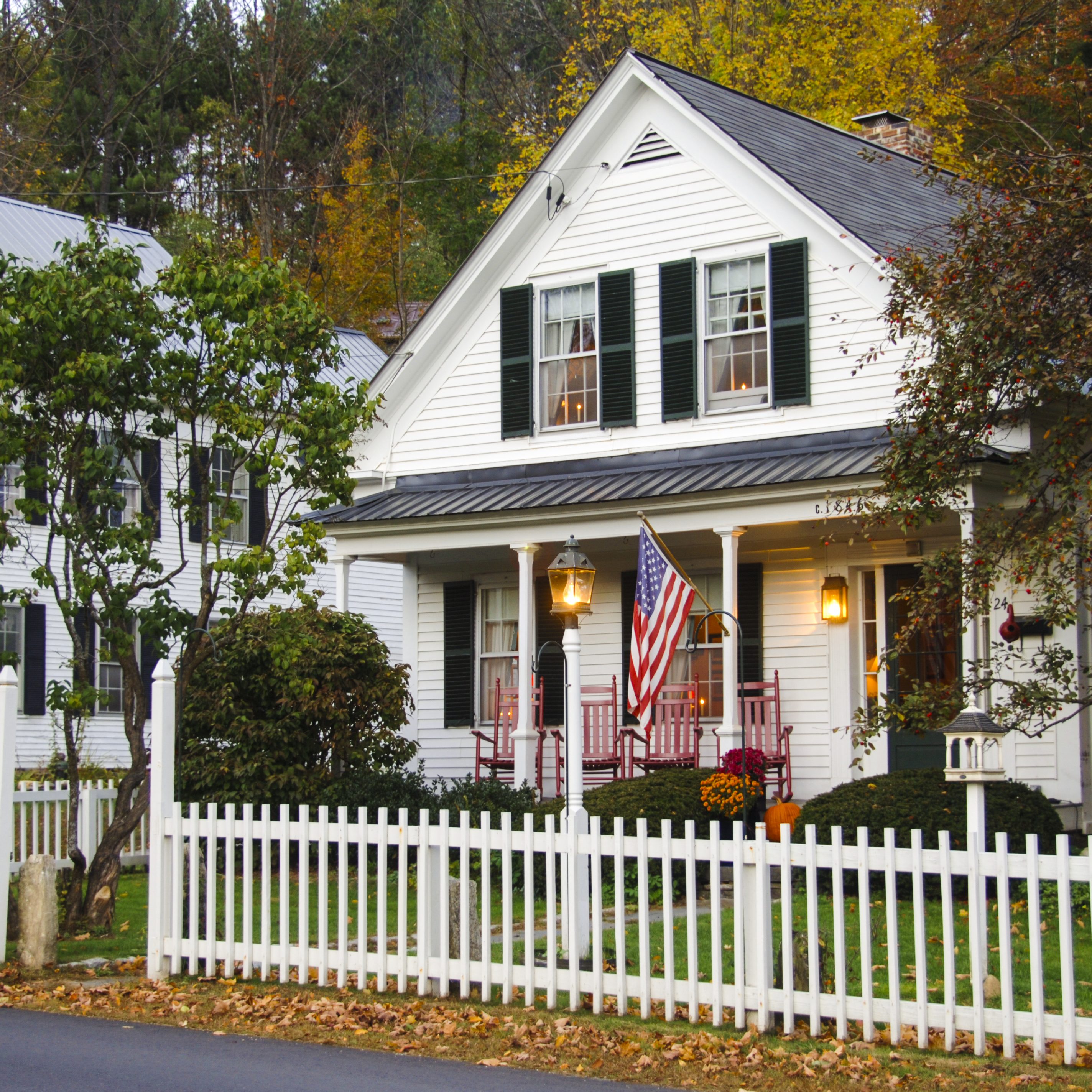 White clapboard house with a white picket fence
